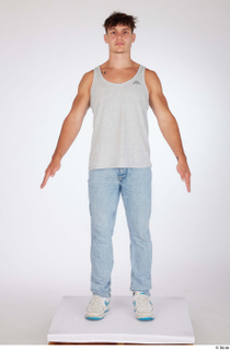 Darren a-poses blue jeans casual dressed grey tank top standing…